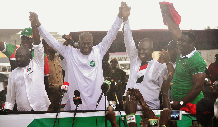  Vice President Amissah-Authur (middle) raises the hands of Mr Richard Ofori Agyemang (left) and Mr John Alexander Ackon at a joint campaign launch. Picture: EMMANUEL BAAH